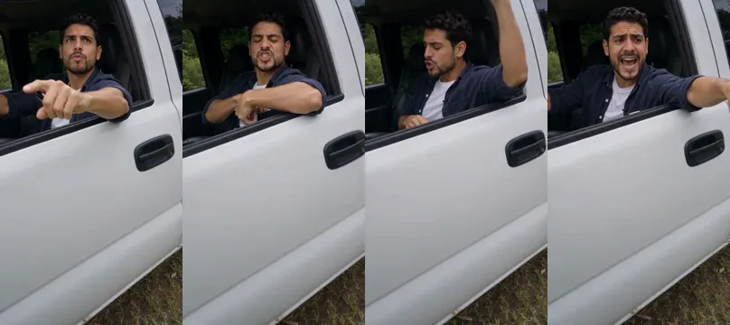 Four frames from one vertical video of a bearded man in a navy overshirt at the wheel of a white pickup: pointing at the camera, listening with a frown, throwing a hand back over his shoulder, and pointing out of the window